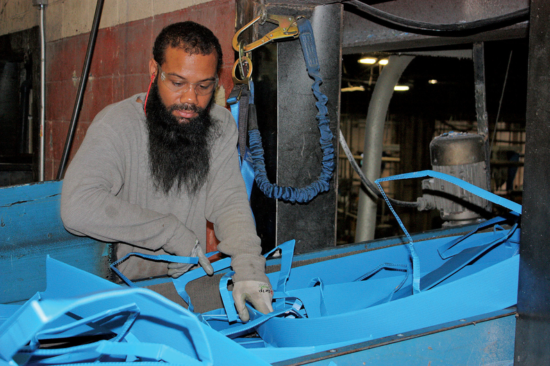 Man working with plastic in manufacturing factory